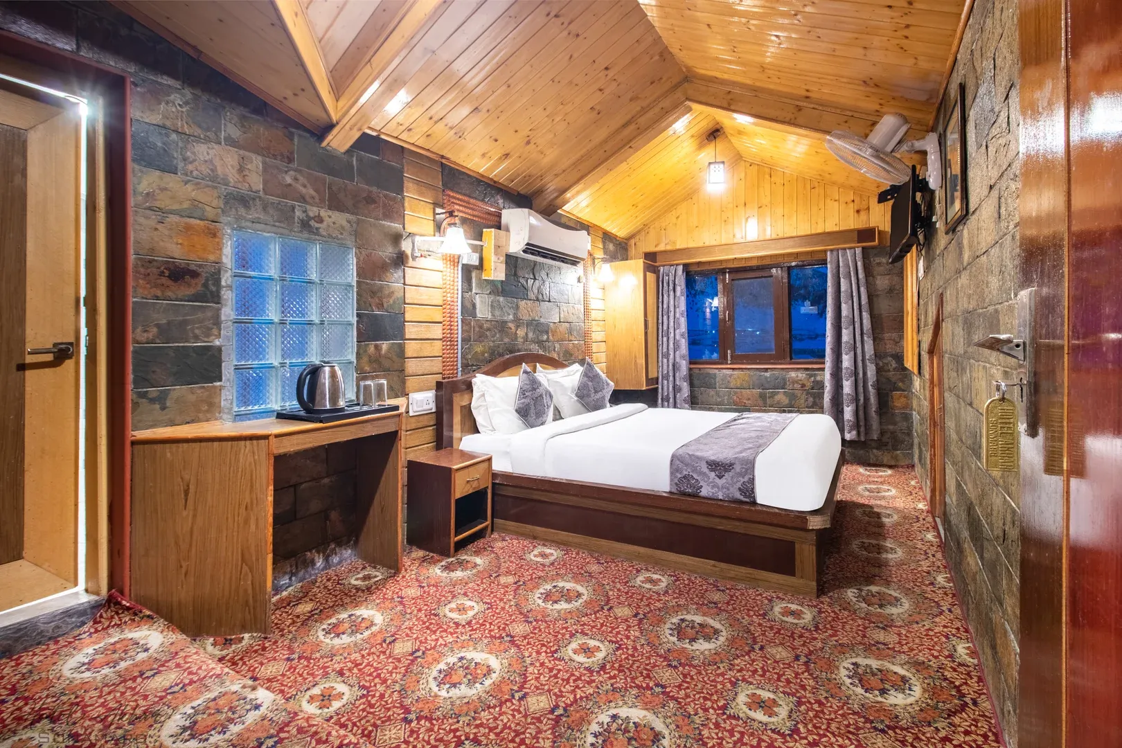 Elegant Sonmarg hotel bedroom interior view.