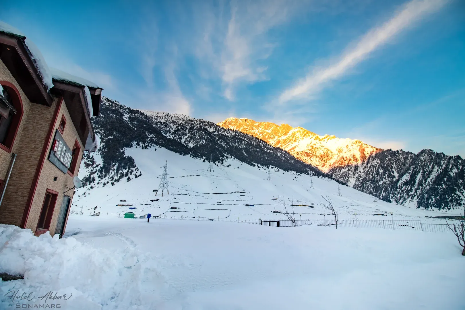 Majestic snowy mountains against bright blue sky