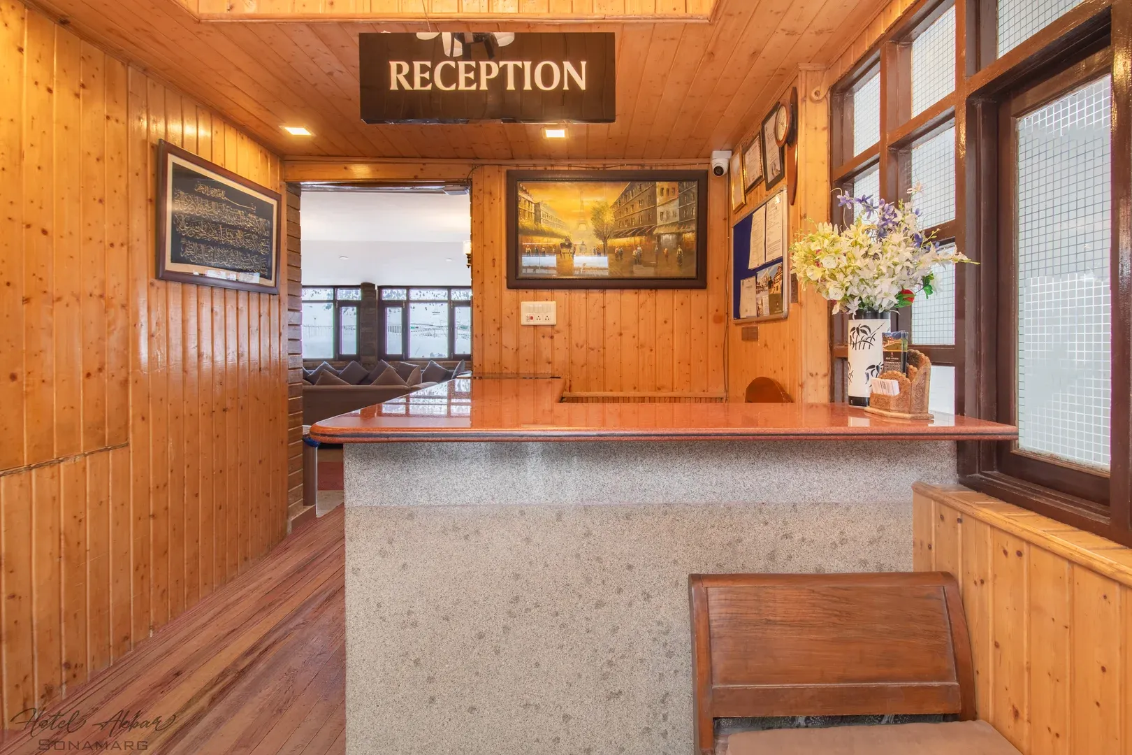Warm wood reception desk, welcoming hotel interior.